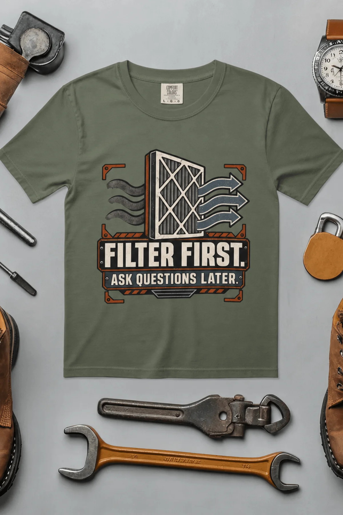 T-Shirt — "Filter First. Ask Questions Later." HVAC Air Filter Graphic — moss t-shirt, flat-lay product photo | Pressure Tested Co
