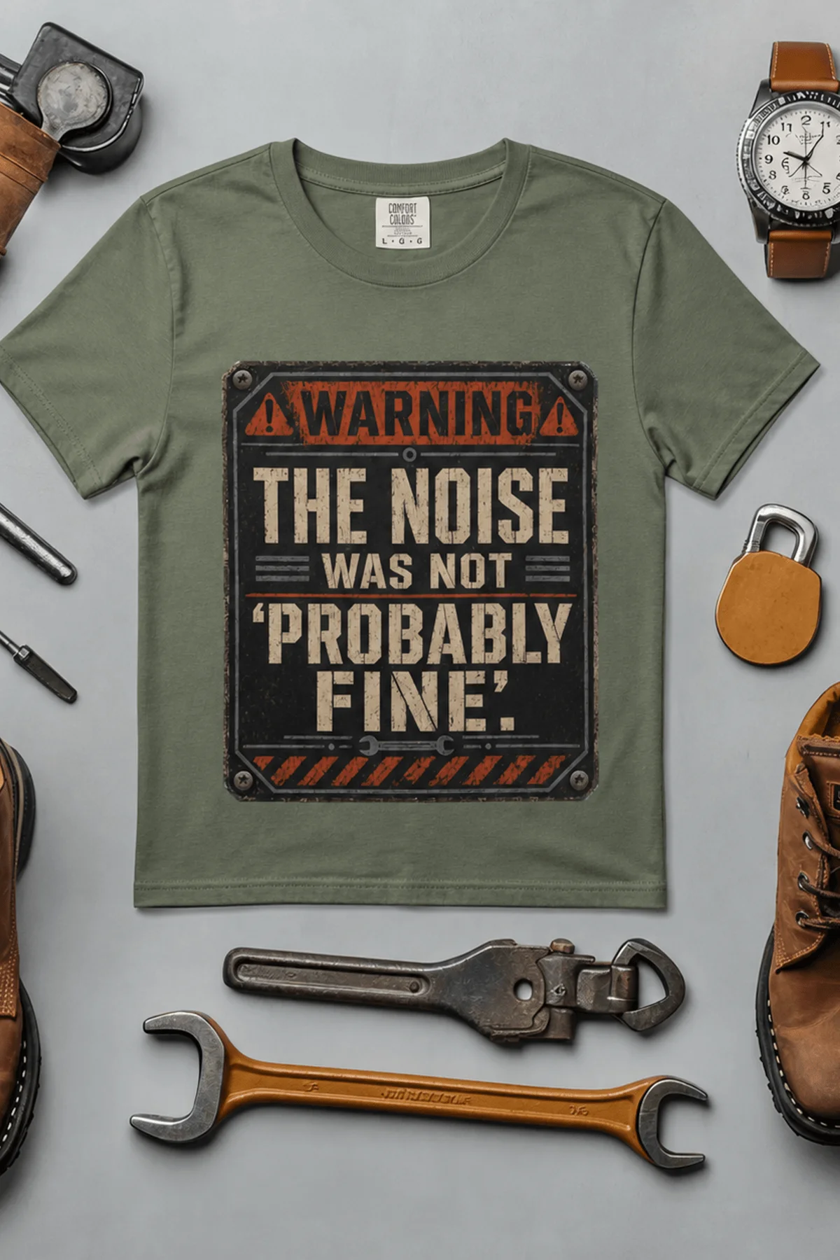 Warning Sign T-Shirt — "The Noise Was Not 'Probably Fine'" Vintage Graphic Tee — moss t-shirt, flat-lay product photo | Pressure Tested Co