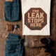 "The Leak Stops Here" Stop Sign Badge Style — Plumbing Repair Tech Humorous Tee — natural t-shirt, flat-lay product photo | Pressure Tested Co