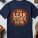 "The Leak Stops Here" Stop Sign Badge Style — Plumbing Repair Tech Humorous Tee — navy t-shirt, flat-lay product photo | Pressure Tested Co