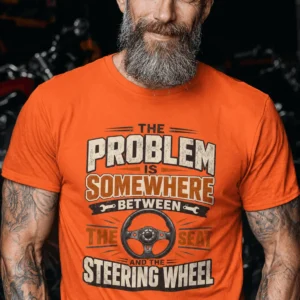 Driving Humor T-Shirt — "The Problem Is Somewhere Between The Seat And The Steering Wheel" — orange t-shirt, model photo | Pressure Tested Co
