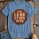 "The Leak Stops Here" Stop Sign Badge Style — Plumbing Repair Tech Humorous Tee — steel-blue t-shirt, flat-lay product photo | Pressure Tested Co