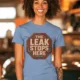 "The Leak Stops Here" Stop Sign Badge Style — Plumbing Repair Tech Humorous Tee — steel-blue t-shirt, model photo | Pressure Tested Co