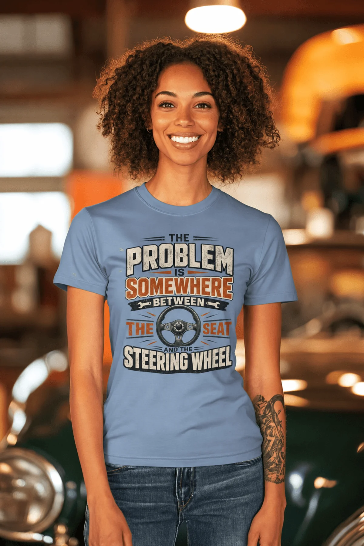 Driving Humor T-Shirt — "The Problem Is Somewhere Between The Seat And The Steering Wheel" — steel-blue t-shirt, model photo | Pressure Tested Co