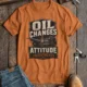 'Oil Changes and Attitude Adjustments' T-Shirt — Funny Retro Industrial Mechanic's Tee — yam t-shirt, flat-lay product photo | Pressure Tested Co