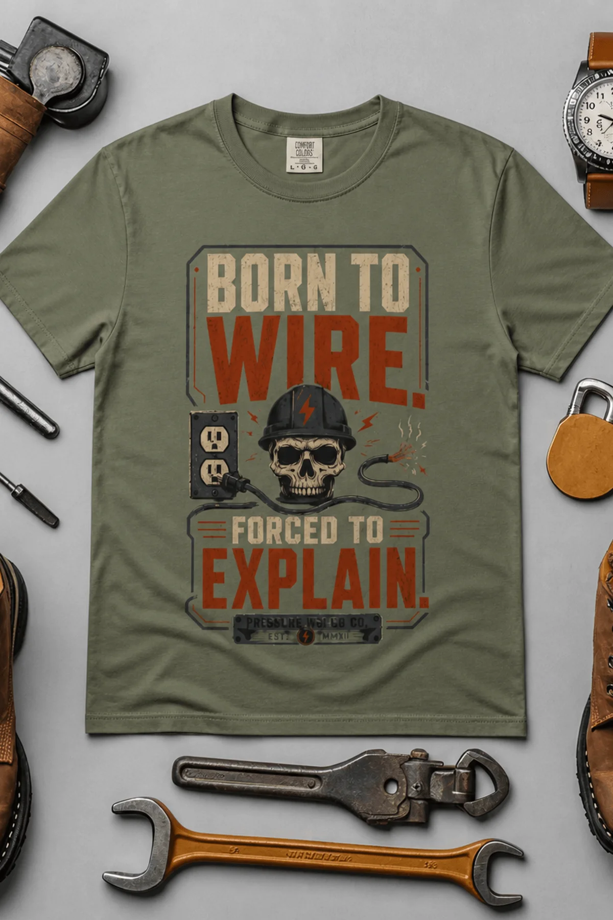 Electrician T-Shirt — "Born to Wire, Forced to Explain" Vintage Skull Tee — moss t-shirt, flat-lay product photo | Pressure Tested Co