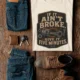 T-Shirt — "If It Ain't Broke, Give It Five Minutes" Vintage Mechanic Tee — natural t-shirt, flat-lay product photo | Pressure Tested Co