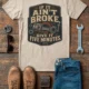 T-Shirt — "If It Ain't Broke, Give It Five Minutes" Vintage Mechanic Tee — silver t-shirt, flat-lay product photo | Pressure Tested Co